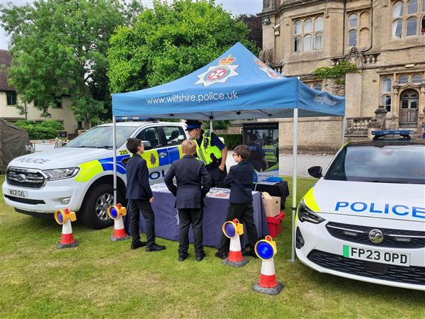police officer talking to children at a fete