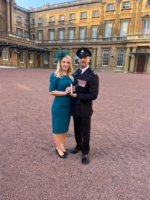 Shammi, and his wife, Davina, stood in the courtyard of Buckingham Palace, jointly holding the Humanitarian Medal he was awarded.