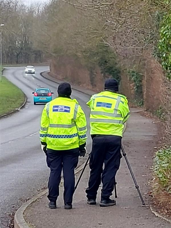 Image of two PCSOs using a handheld speed camera