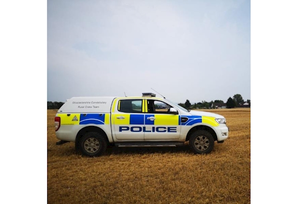 Rural Crime Police Vehicle parked in a field