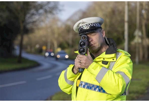 Police officer with a speeding gun