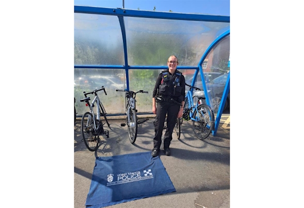 PC Attwood stood in front of a bike shed at Worcester Hospital