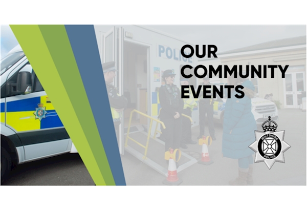 Community Event Update - high vis wearing officers, photographed by the side of a mobile police station, talking to a member of the public.