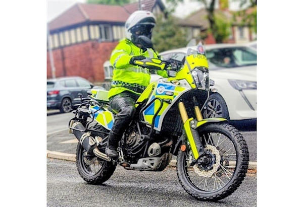GMP Hi-Viz Motorcyclist in action riding a liveried Suzuki Tenere adventure motorcycle
