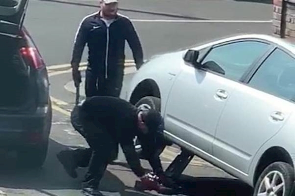 A person lifting a car
AI-generated content may be incorrect.