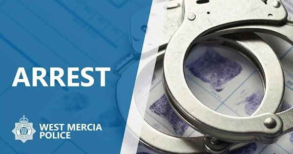 Silver handcuffs on a fingerprint card, with 