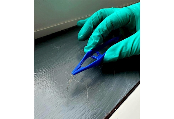 SOCO officers collecting evidence with forceps 