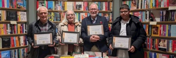 A group of people holding certificates
AI-generated content may be incorrect.