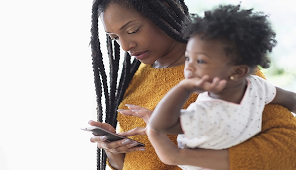 A person holding a baby and looking at a cellphone

AI-generated content may be incorrect.