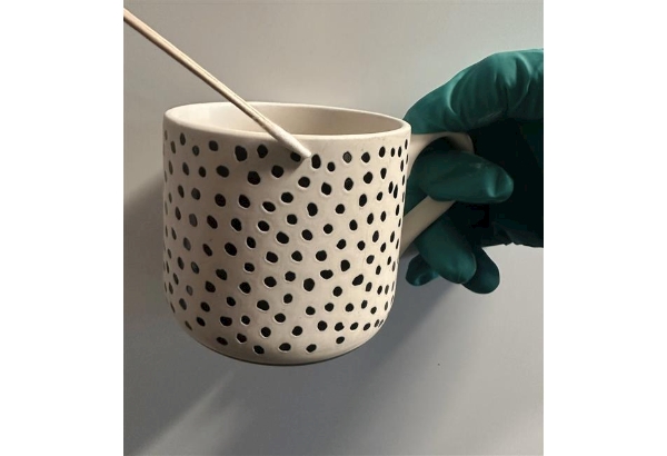 SOCO officers swabbing a teacup
