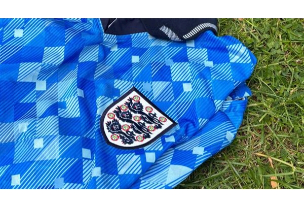 An England football shirt layed on the grass