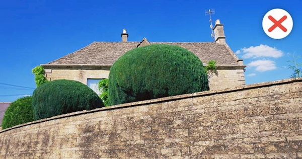 A high stone wall in front of a house