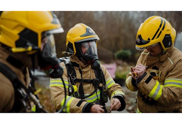 Firefighters wearing breathing apparatus, ready to start a drill activity