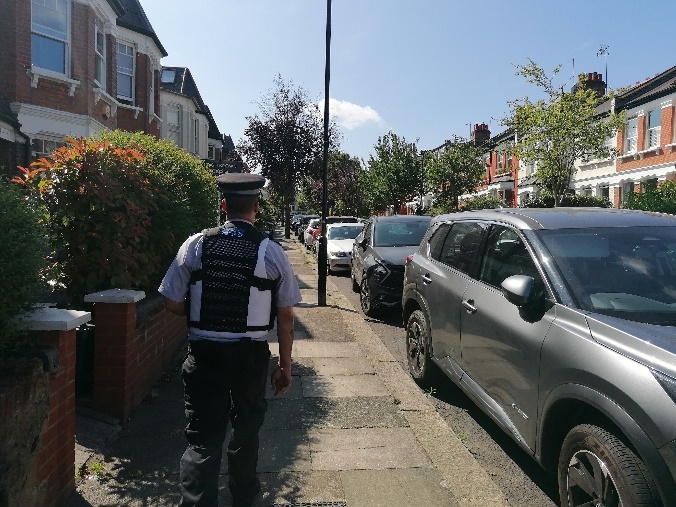 A person walking on a sidewalk with cars parked on the side

AI-generated content may be incorrect.