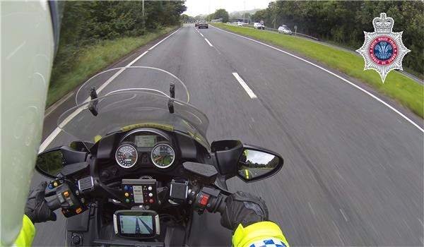 A motorcycle on the road

Description automatically generated
