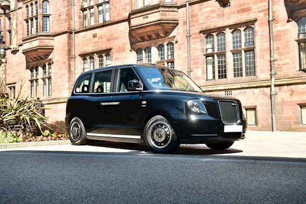 A black car parked on the side of a road

AI-generated content may be incorrect.