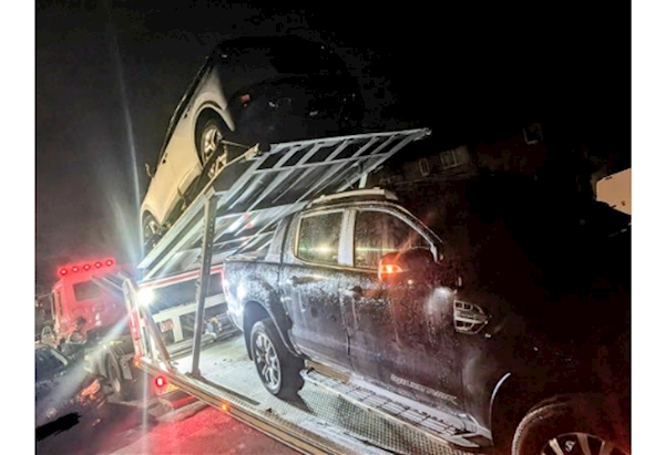 Pickup truck loaded on to split bed slide loading recovery truck.