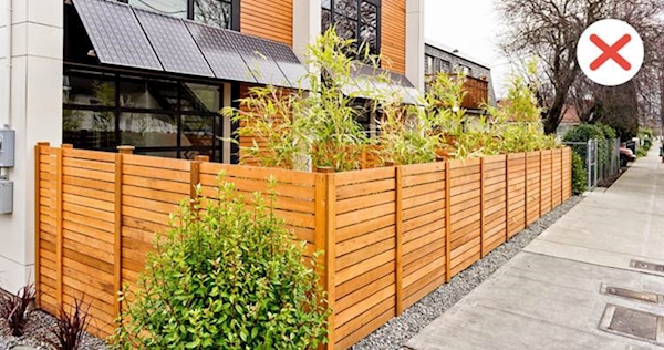 A tall fence in front of a building