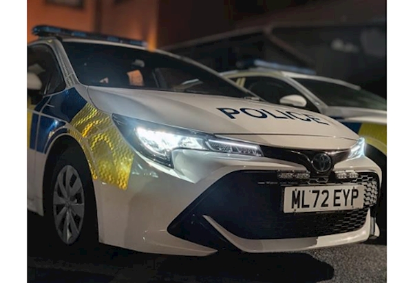 GMP Liveried Toyota Corolla Vehicle in the dark with headlights lit