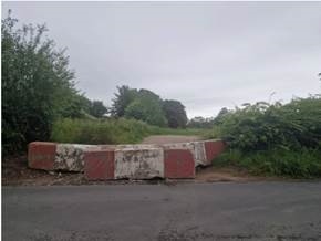 A road with a red and white block

AI-generated content may be incorrect.