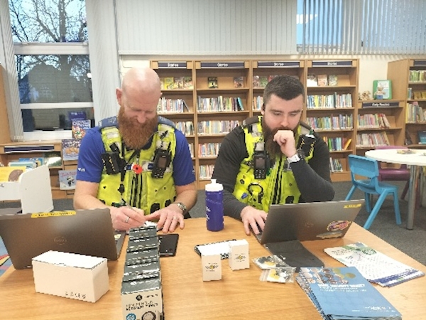 Two men in vests looking at a computer
AI-generated content may be incorrect.