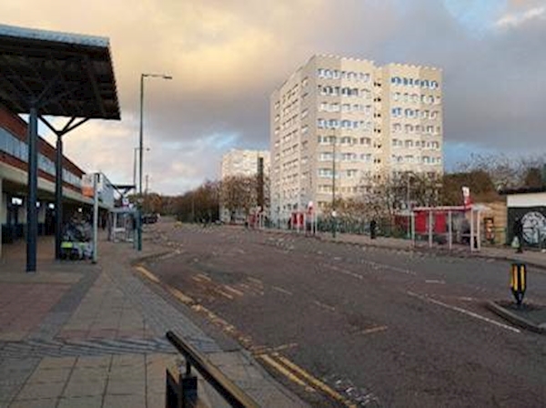 A street with a building in the background
AI-generated content may be incorrect.