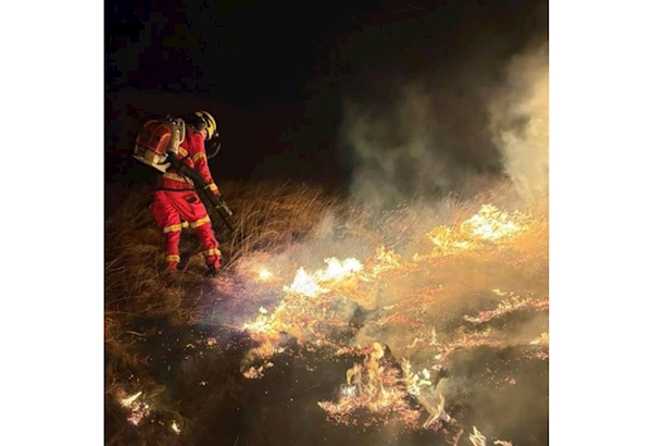 Firefighter tackling wildfire in Lancashire