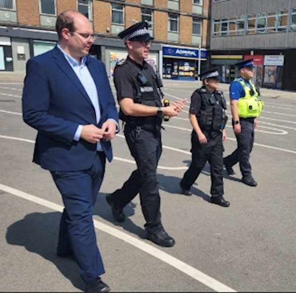 A group of people walking in a parking lot
AI-generated content may be incorrect.