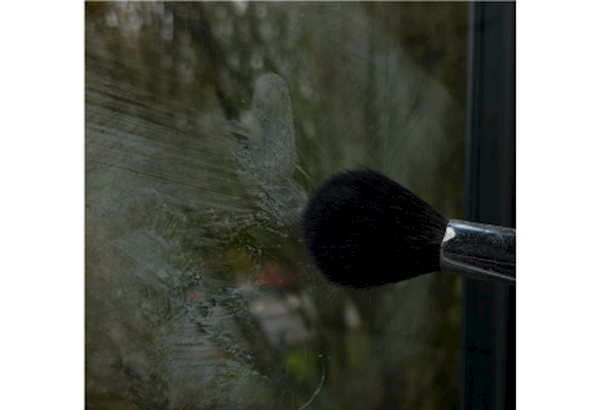 SOCO officers Finger printbrush applying dust to glass window to reveal marks 