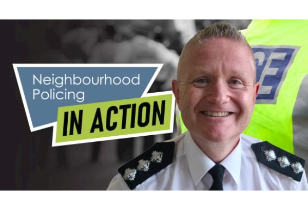 Police officer in front of picture collage