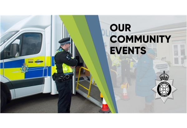 Community Event Update - high vis wearing officers, photographed by the side of a mobile police station, talking to a member of the public.