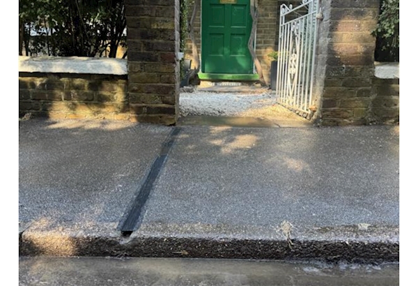 A cross-pavement electric vehicle charging channel.