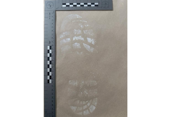SOCO officers measuring footprint