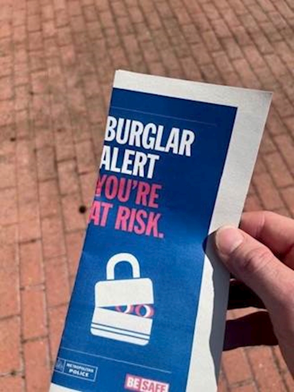 A hand holding a blue and white flyer

AI-generated content may be incorrect.