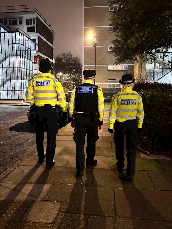 A group of police officers walking on a sidewalk

AI-generated content may be incorrect.