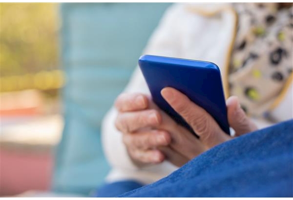 Stock image of woman's hands holding a blue smartphone