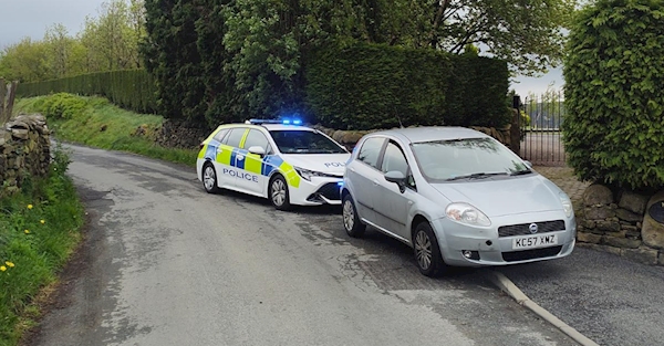 A police car and a silver car on the road

AI-generated content may be incorrect.