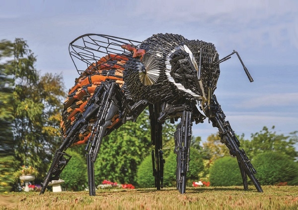 Bee sculpture made from knives and guns
