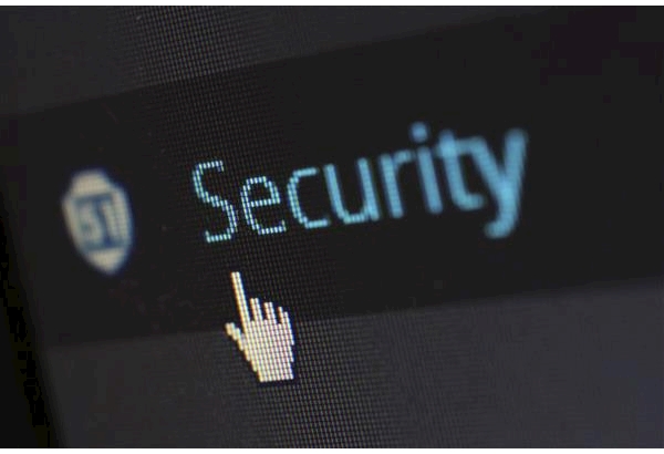 An image of a screen that has a black background. A white computer cursor is hovering over a blue button that says security. 