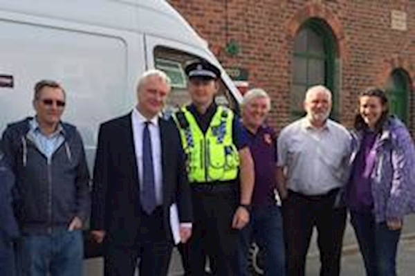 A group of people standing next to a white van

AI-generated content may be incorrect.